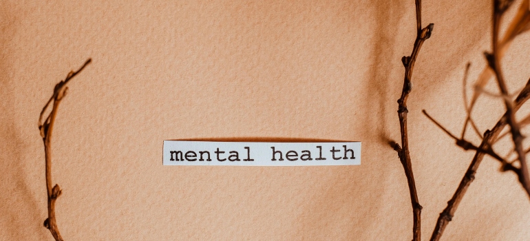 Piece of paper on orange background that says mental health