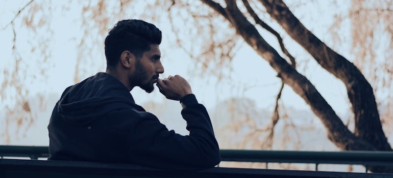 Man sitting on a bench in a park.