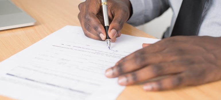 Man signing a contract.