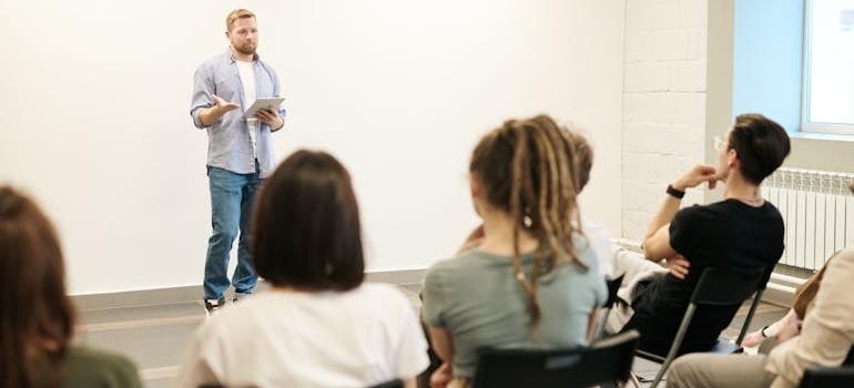 Man educating managers on how to notice signs of addiction.