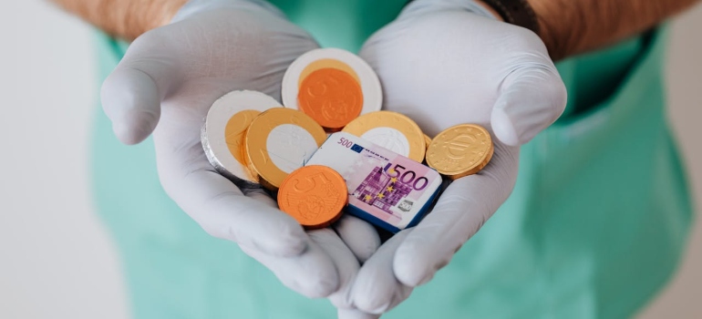 A doctor is holding coins and fake money