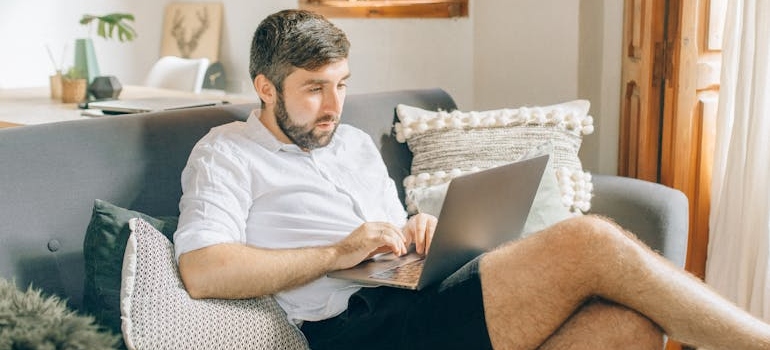 Man sitting on the couch and working.