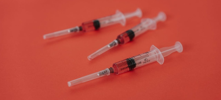 Syringes on the red background.