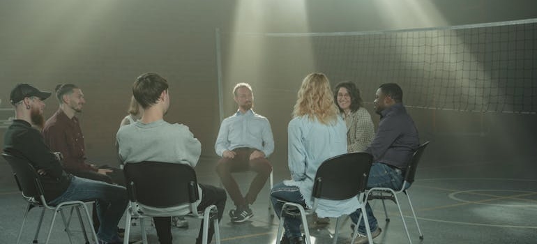 Support group having a meeting in a school gym.