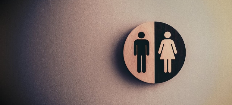 A woman and a man sign on the pink background