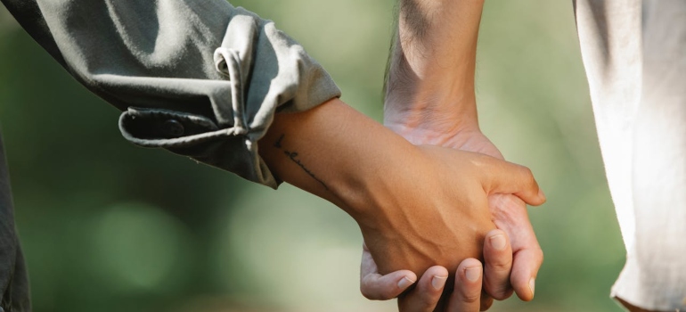 A couple holding hands in the park