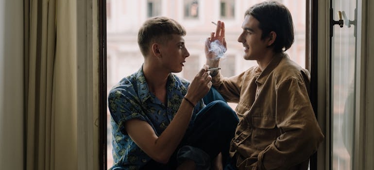 Two boys smoking cigarettes.