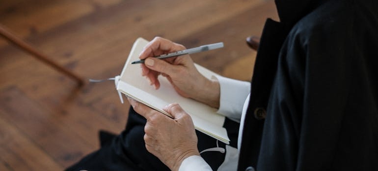 Psychiatrist writing down symptoms in her notebook.