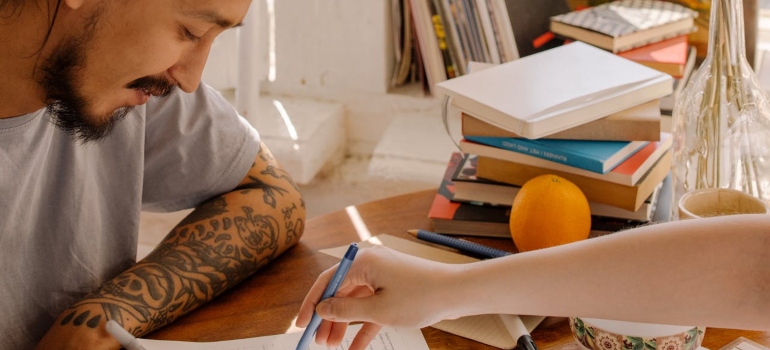 Picture of a happy couple learning together represents why educatiing yourself is important when you are Balancing Self-Care While Supporting an Addicted Loved One