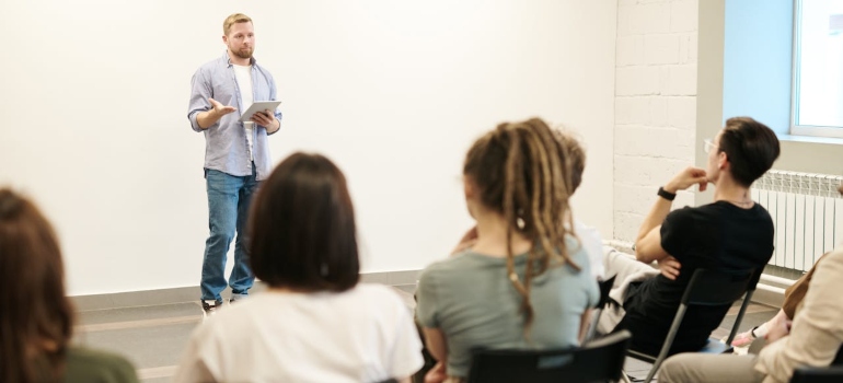 a man giving speech to students