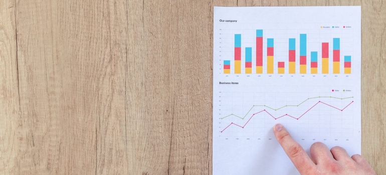 Person pointing paper line graph