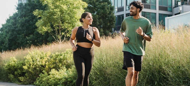 Man and woman running and talking to each other.