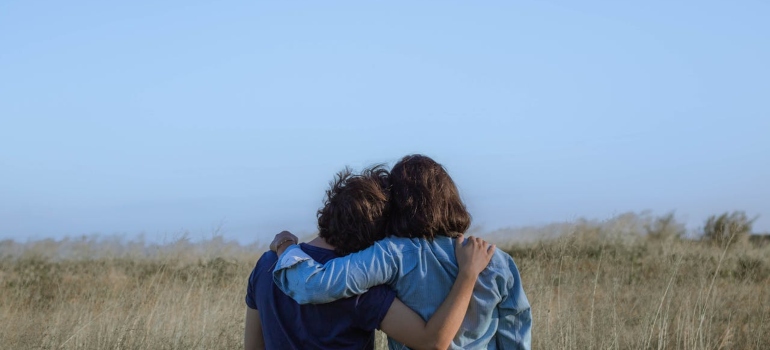 A couple hugging in the field