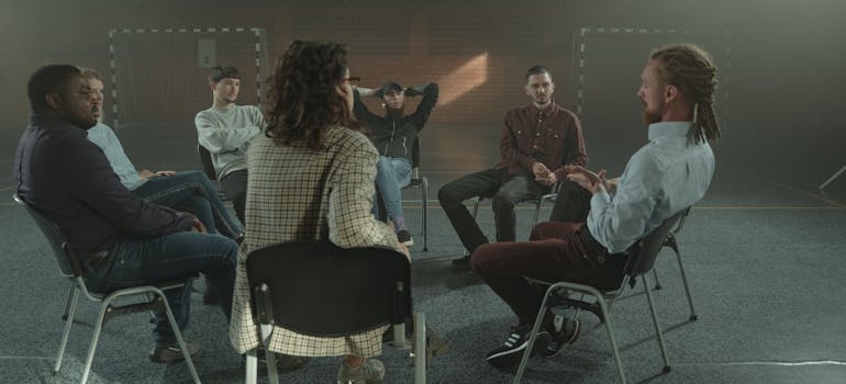 A picture of a group therapy session for addicts in rehab.