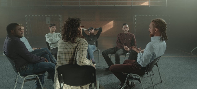 People Sitting in circle on group therapy