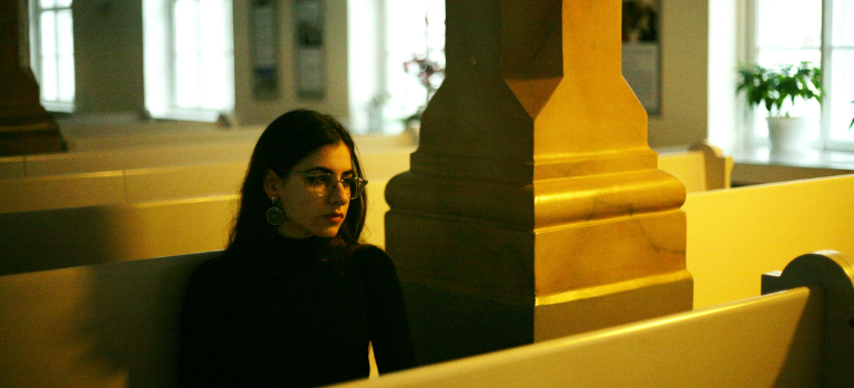 a woman in a church with her thoughts