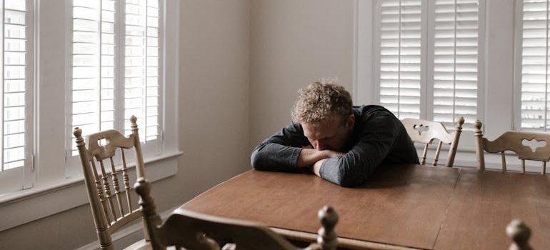 Man sitting at a table and leaning on it.