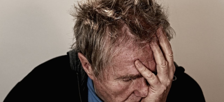 Man holding his face