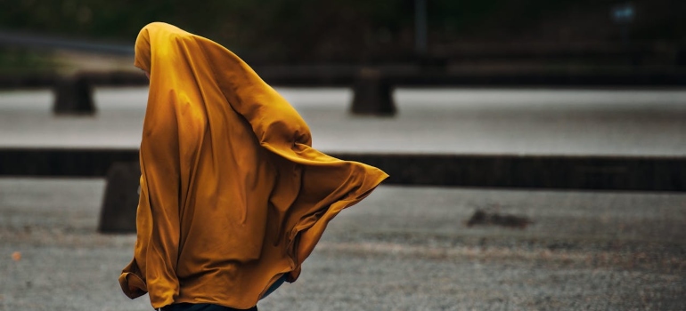 a muslim girl walking on the street