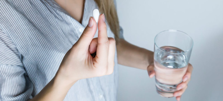 a woman taking the medicine