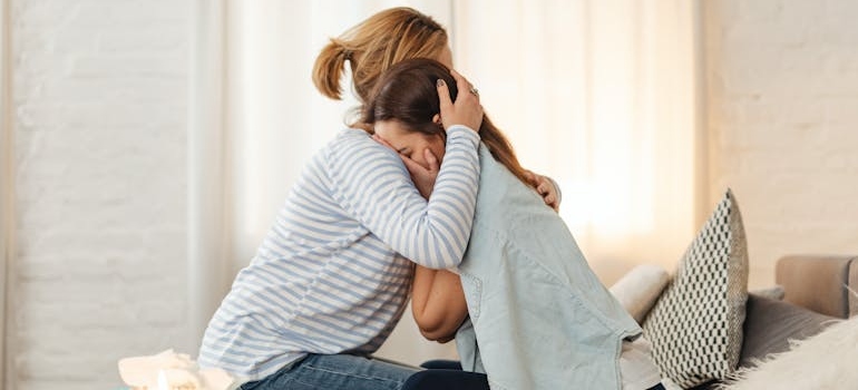 Woman hugging her daughter.