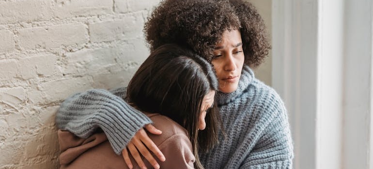 Two women hugging each other.