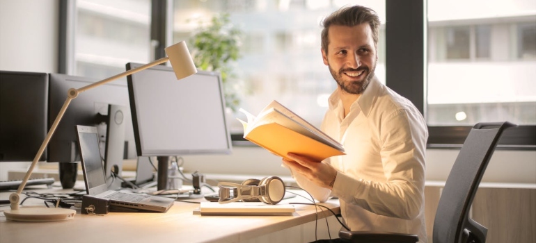 All You Need to Know About Demerol Addiction represented via man smiling in his office who is probably in an outpatient care