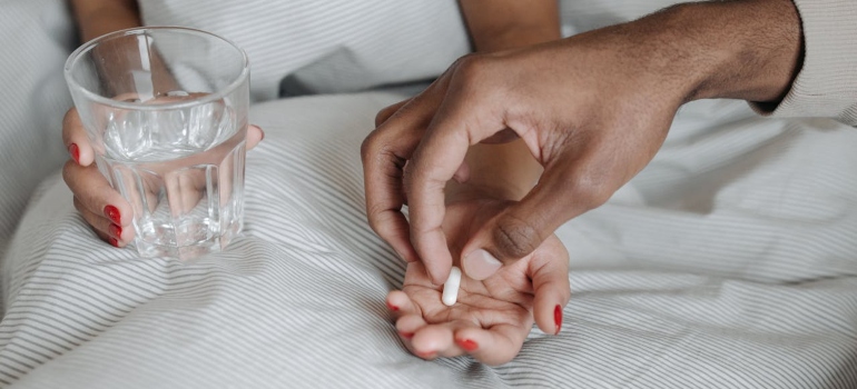 a man giving a medicine to a woman to Recognize the Early Signs of Ambien Dependence