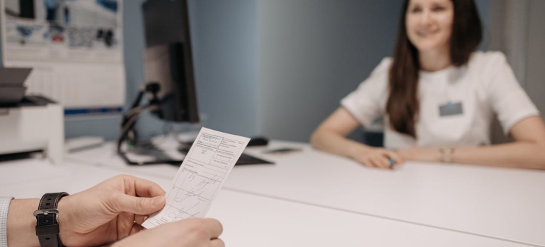 a patient looking at a prescription in a doctor's office