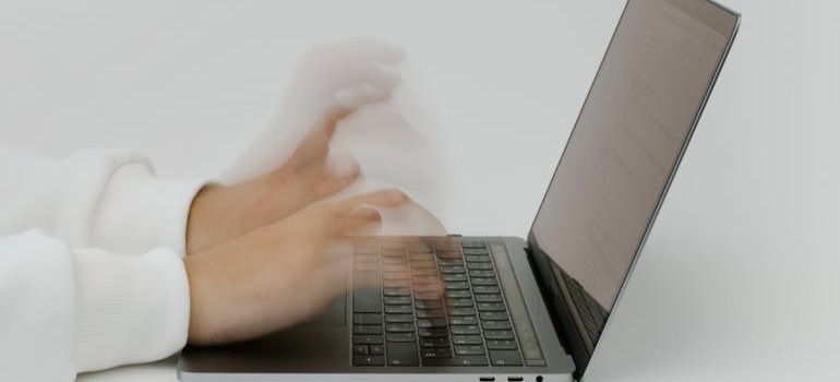 A person writing on a lap top