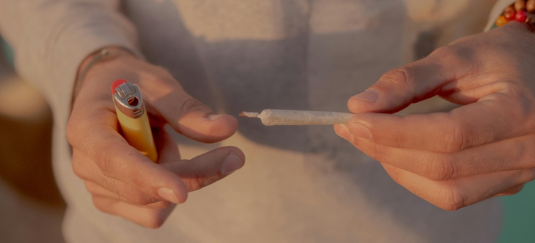 A man is holding marijuana in his hands.