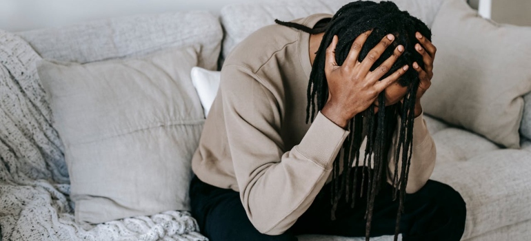 Stressed man sitting on a couch