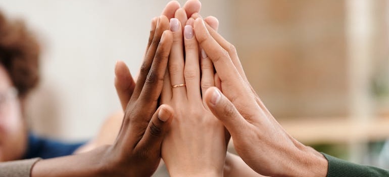 People of different ethnicities high fiving.