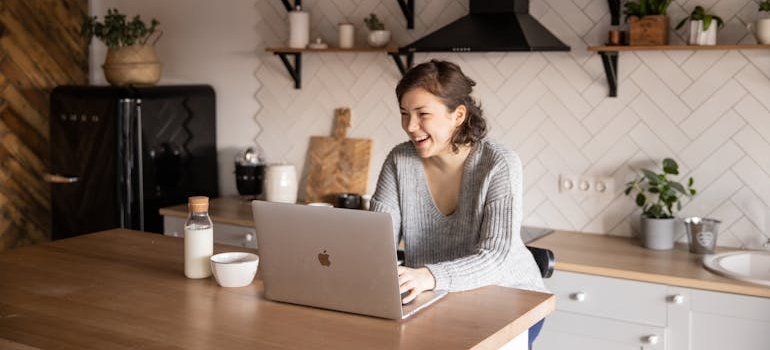 Woman using her laptop in the kitchen.