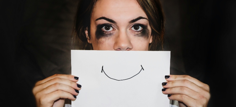 A sad young girl with a printed smiley