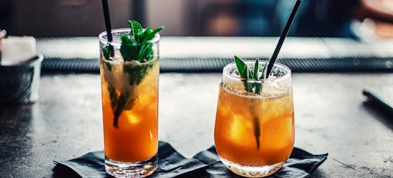 Two mocktail glasses placed on a bar.