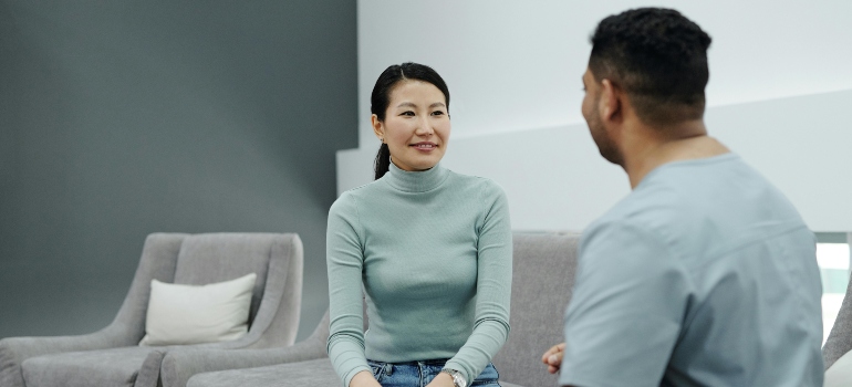 Woman talking to a doctor about emergency detox services and insurance coverage