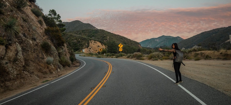 a woman hitchhiking