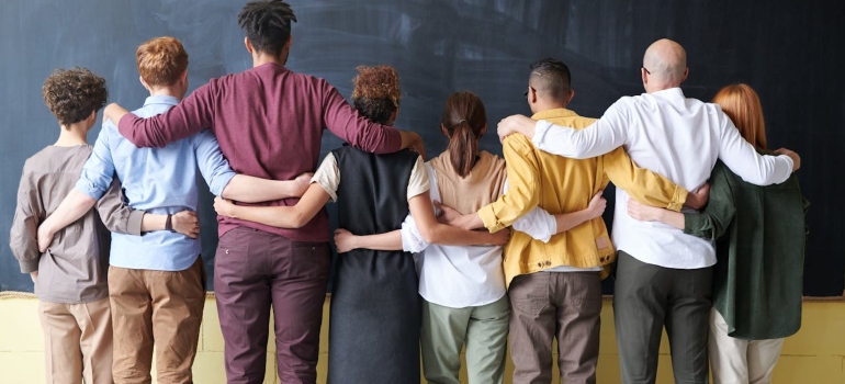 people hugging in front of the blackboard