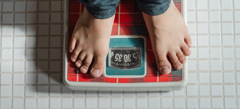 person measuring his weight