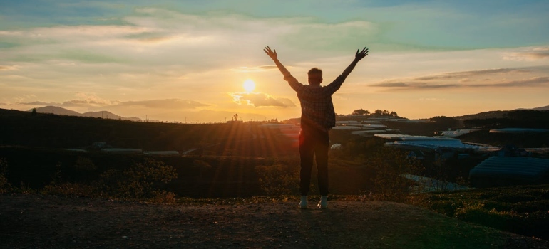 a man looking at the sunset as one of the seven Things You Will Love About Being Sober in West Virginia