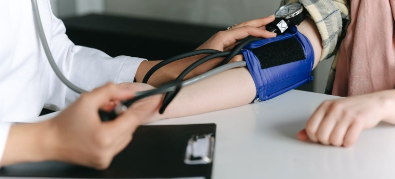 a doctor checking the patient's blood pressure