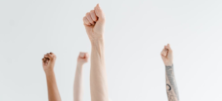 raised hands advocating for the improvement of Addiction and Homelessness in Fairmont