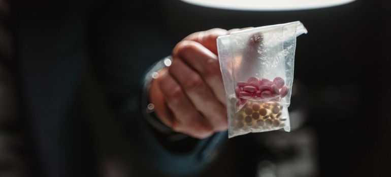 a man holding a bag of drugs