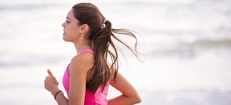 a woman jogging on the beach