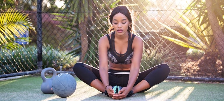 Woman in sport gear stretching.