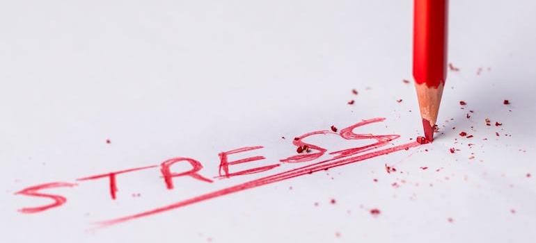 Stress written in red ink as something to avoid when maintaining motivation throughout your recovery process.