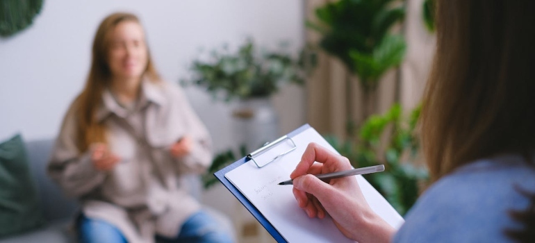 a woman talking to a therapist about Handling Social Situations While Staying Sober