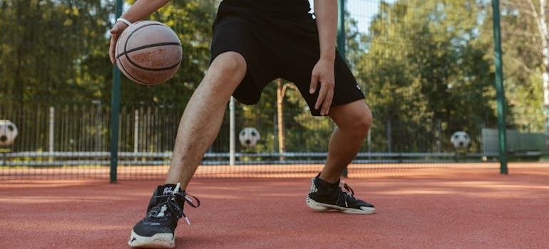 A person playing basketball which is one of the ways of coping with cravings in early sobriety