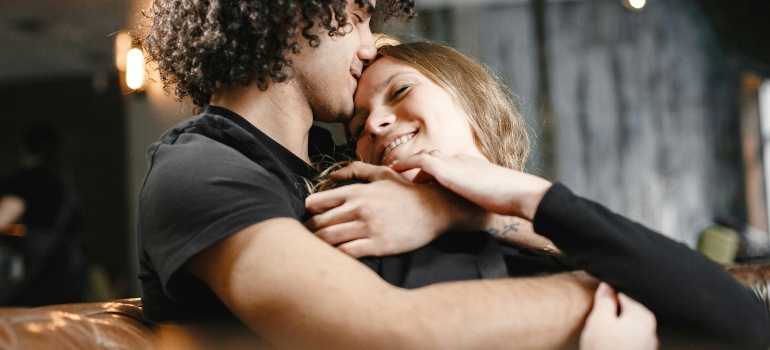 A man is hugging his girlfriend and giving her support.